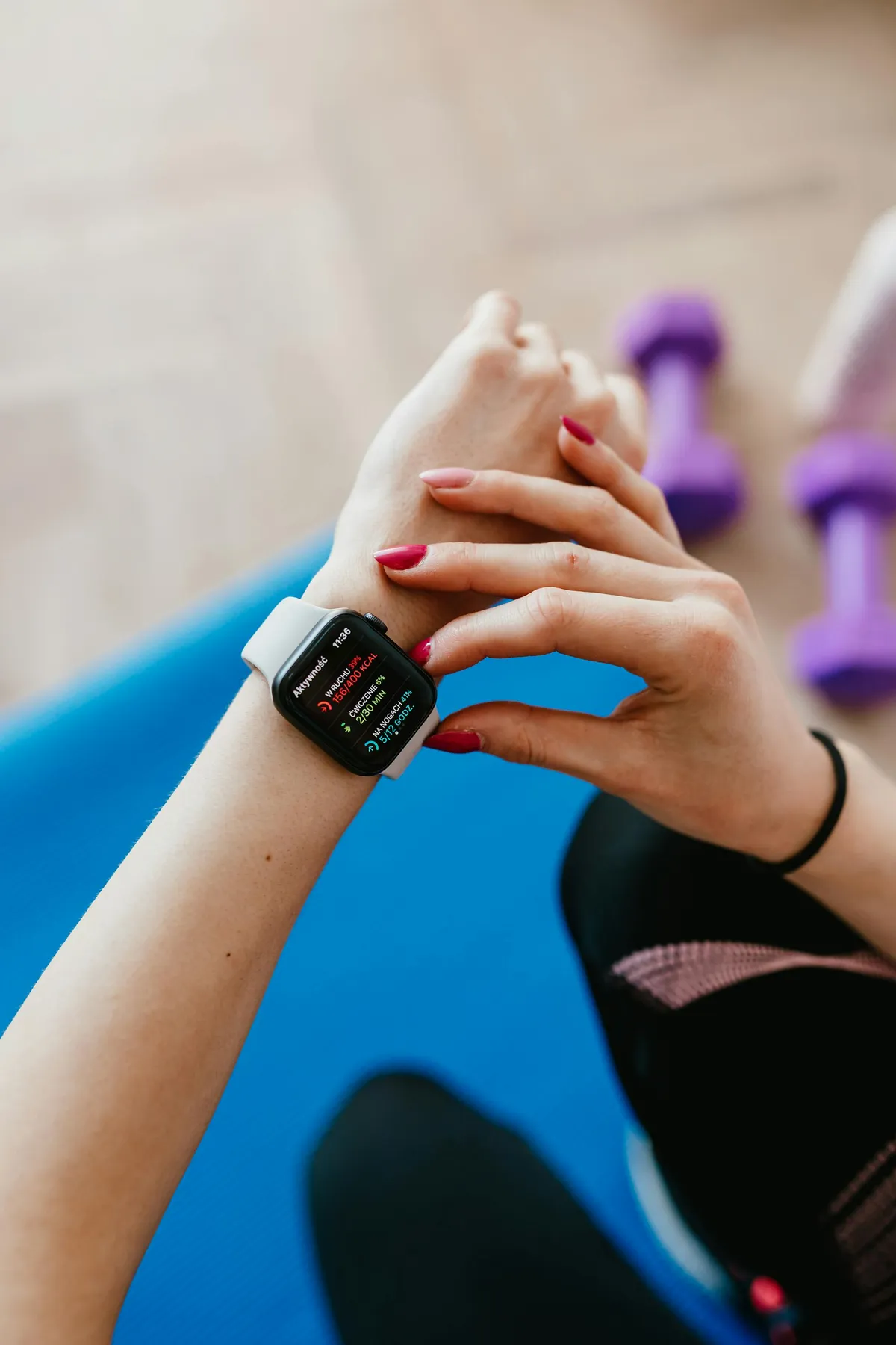 Person using a fitness app on smartphone during a home workout session
