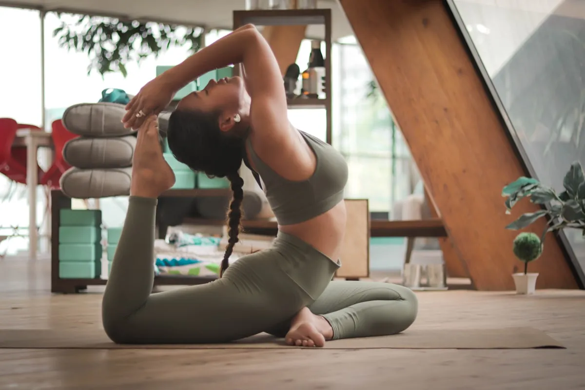 Person doing bodyweight floor exercise on a mat in a home living room with natural light