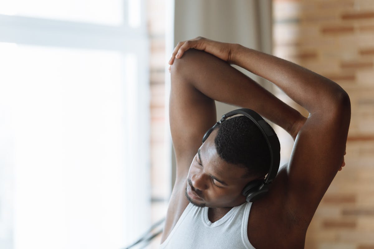 Person cooling down with gentle stretching after a short bodyweight workout at home