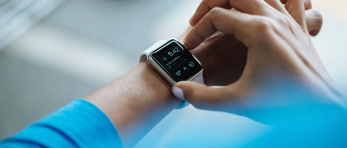 Persona che controlla i passi giornalieri su uno smartwatch durante una camminata