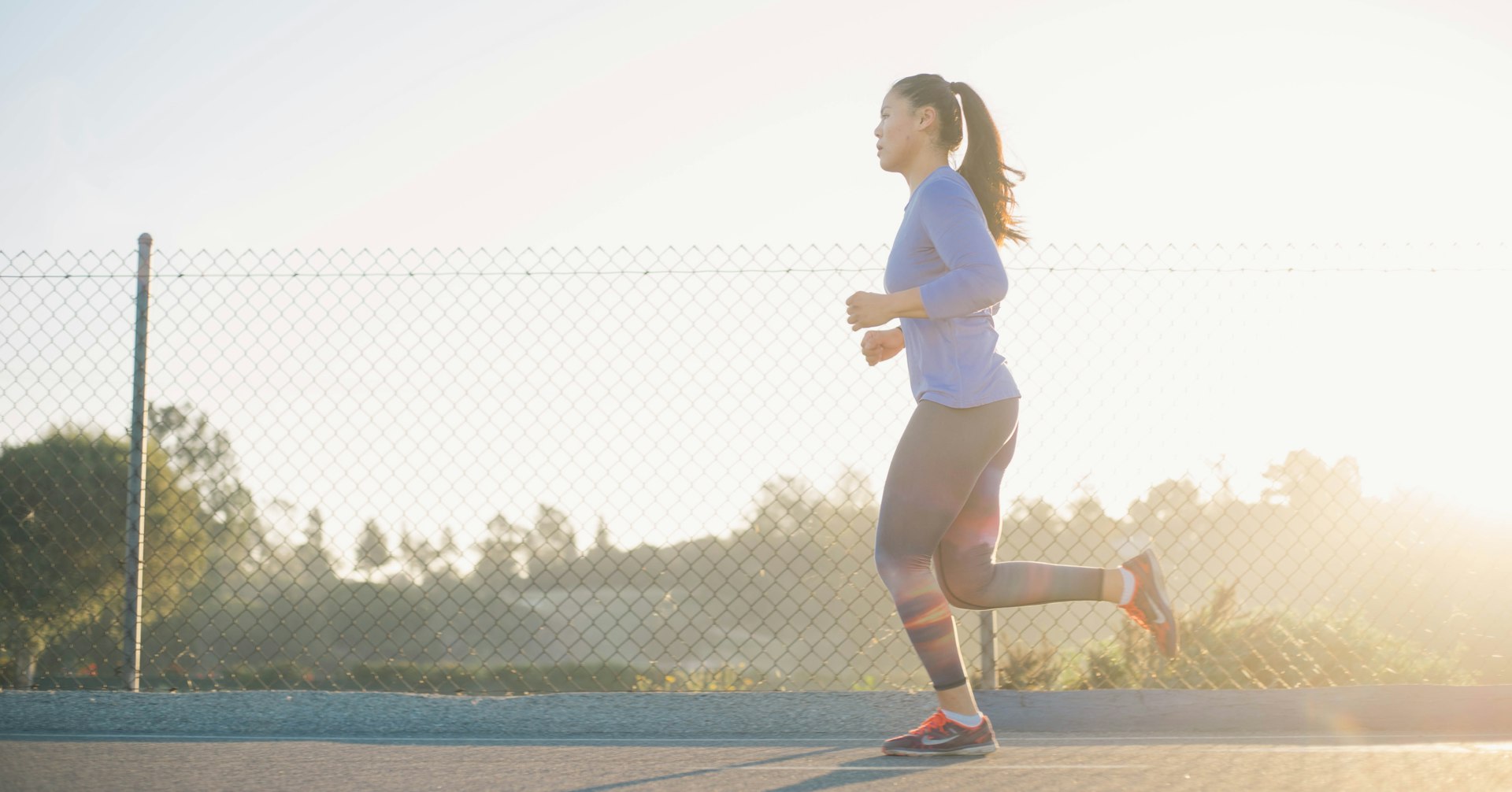 Person jogging outdoors at dawn as a routine to channel focus and energy