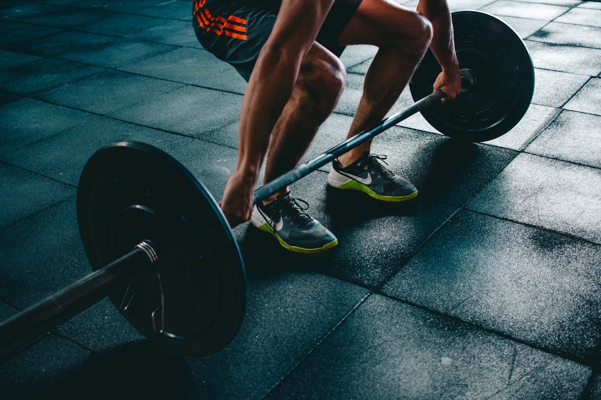 Woman performing a low-impact squat variation during a home HIIT workout