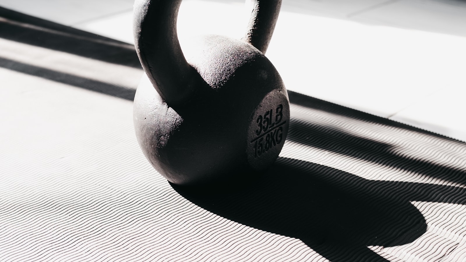 Kettlebell on a workout mat in bright home light