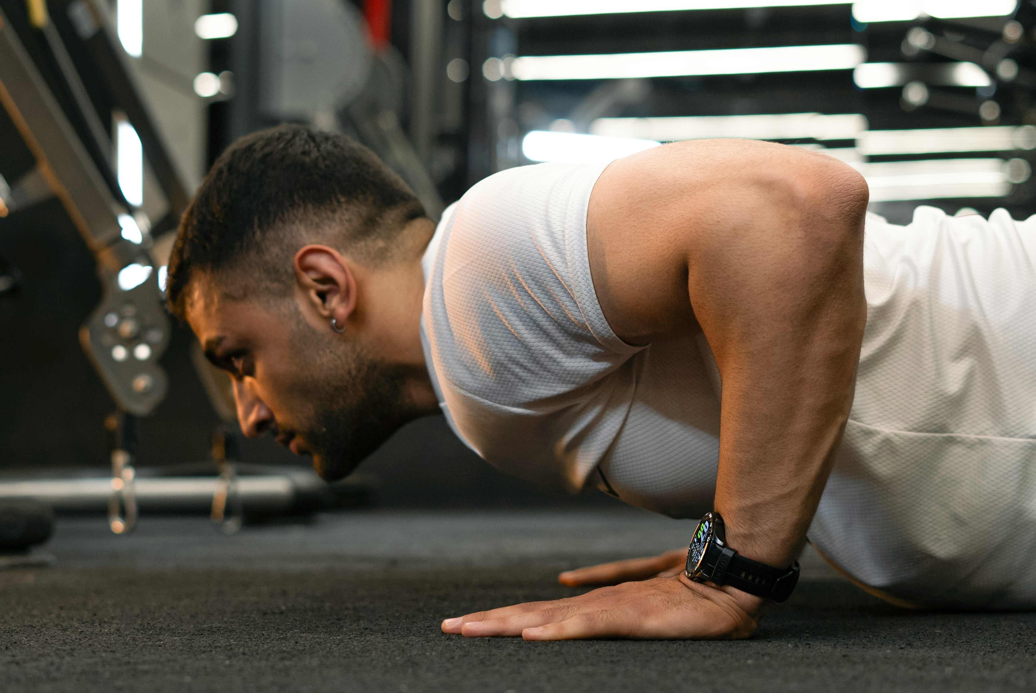Person holding the bottom position of a controlled push-up during a bodyweight workout