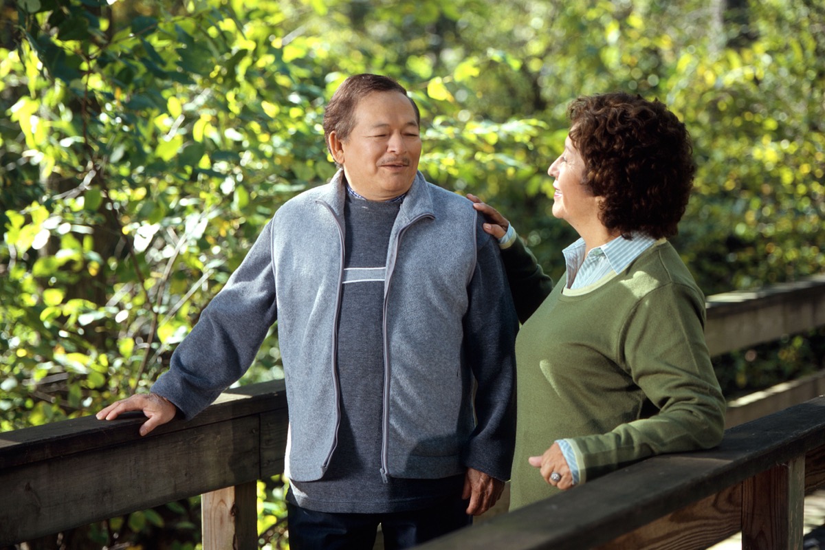 Person taking a relaxed walk outside after a meal in casual clothes